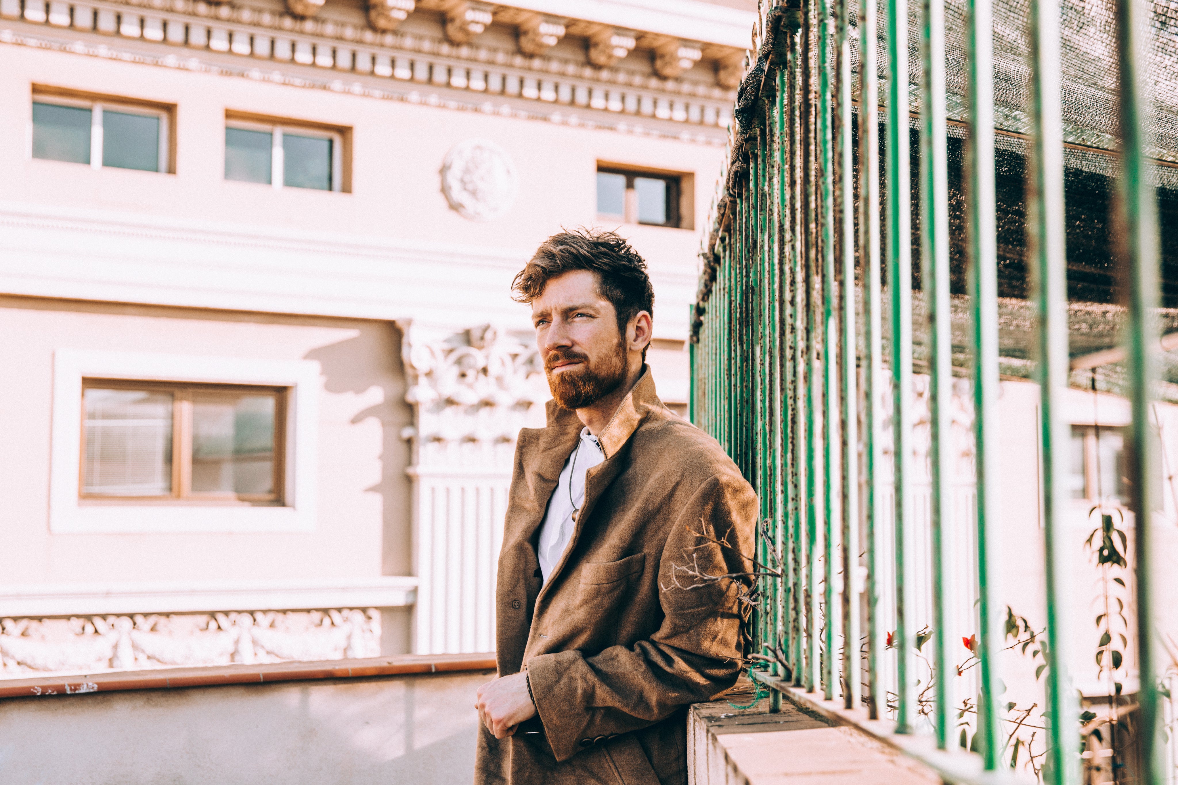 files/man-in-coat-leans-against-railing.jpg