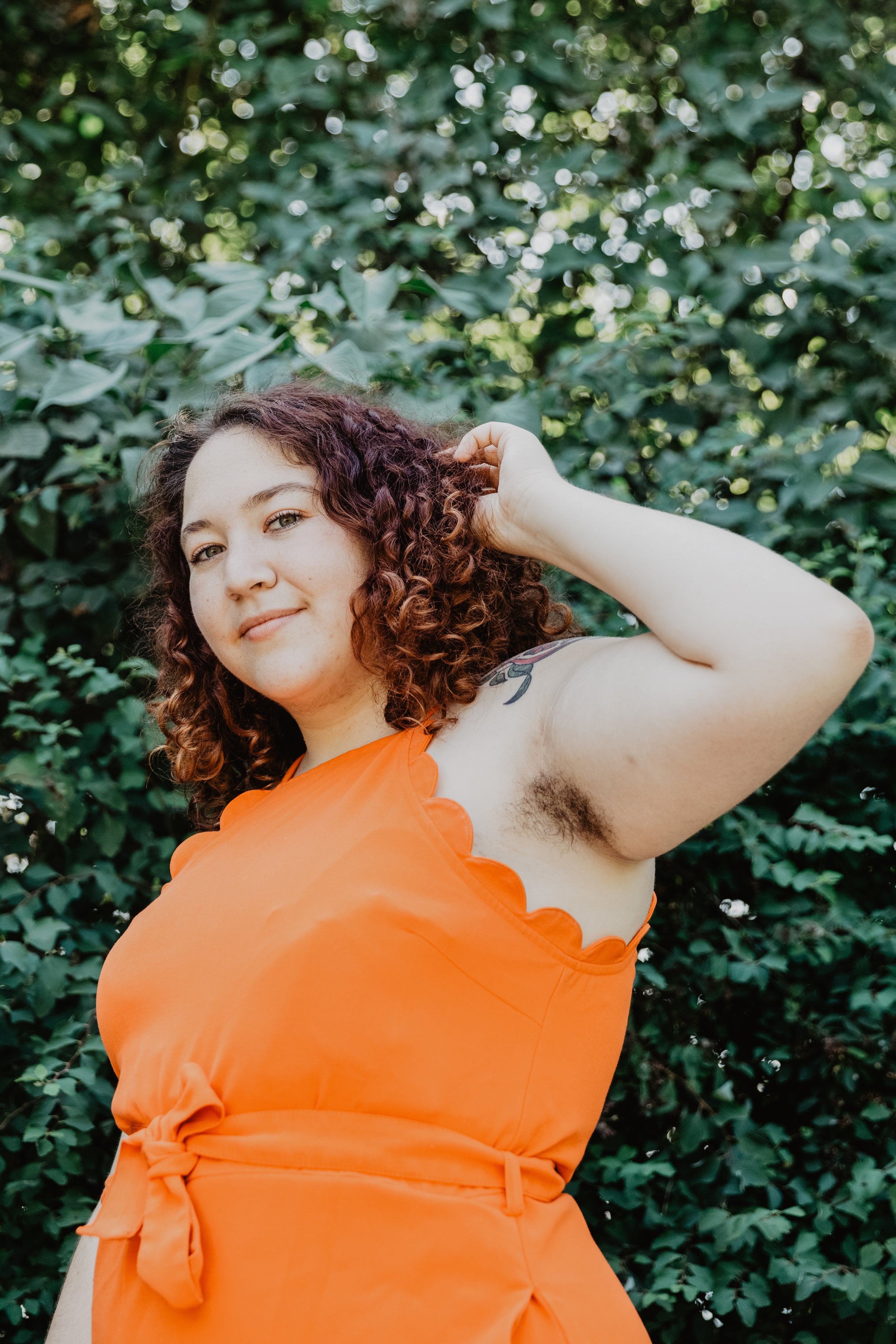 files/woman-in-orange-top-by-green-plant.jpg